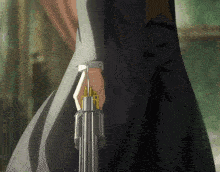 a person holding a gun in their hand with a gold ring around it