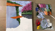 a painting on a canvas next to a palette with the words made in animatica on the bottom