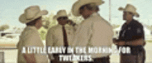 a group of cowboys and police officers are standing next to each other .