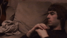 a man laying on a couch with the bbc logo on the bottom right