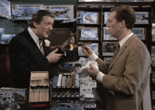 two men are standing in front of a display of spitfire models
