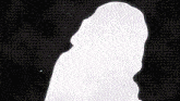 a silhouette of a person 's face is against a black background .
