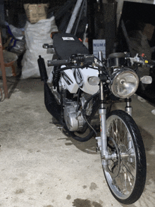 a motorcycle is parked in a garage next to a sign that says numo