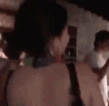 a blurry picture of a woman standing in a room with a baby .