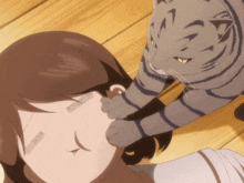 a cat petting a woman 's face with its paw
