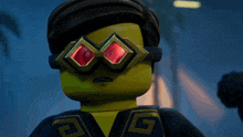 a close up of a lego character wearing glasses with red lenses