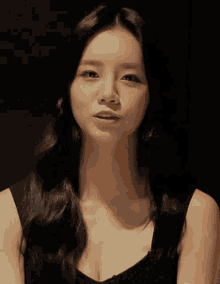 a close up of a woman 's face with a dark background
