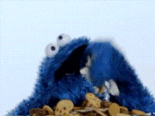 cookie monster is eating a pile of cereal