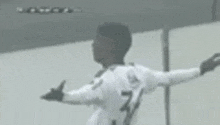 a soccer player wearing a white jersey with the number 7 on it