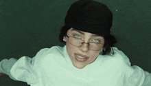 a woman wearing glasses and a black beanie
