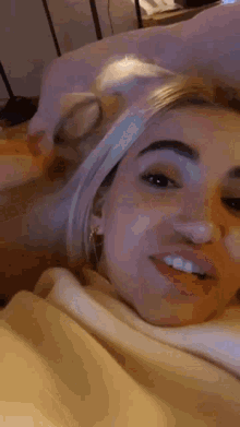 a woman wearing glasses is laying on a bed with a man .