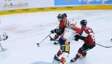 a hockey game is being played and the player in the red jersey has the number 17 on his back