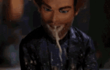 a close up of a person 's face with a lot of liquid coming out of it .
