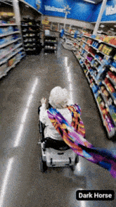 an elderly woman in a wheelchair is walking through a walmart