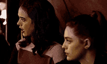 a woman is looking at herself in the mirror .