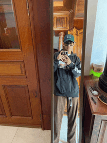a person taking a picture of themselves in a mirror with a tofu container in the background