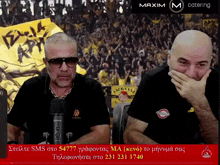 two men are sitting in front of a microphone in front of a crowd and the word maxim is on the bottom right