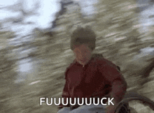 a man in a wheelchair is riding down a hill and making a funny face .