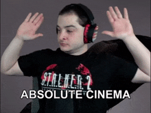 a man wearing headphones and a t-shirt that says stalker 2 absolute cinema