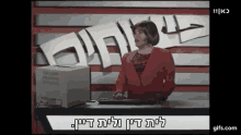 a woman in a red jacket is typing on a computer keyboard in front of a sign that says 111 kc