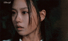 a close up of a woman 's face with a tear running down her nose .