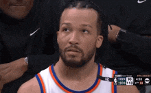 a basketball player is sitting in the stands during a game