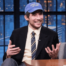 a man in a suit and tie is wearing a hat that says upper tier history