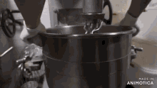 a person is mixing something in a mixer with the words made in animotica below it