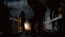 a person is standing in a dark room with smoke coming out of the ceiling