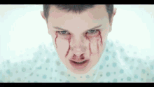 a close up of a person 's face with blood on it .