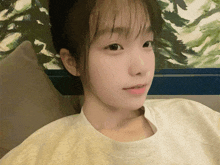 a close up of a girl 's face with a white shirt on