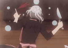 a woman is holding a knife and pointing at something