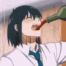 a man is drinking from a bottle with his mouth open