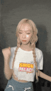 a girl wearing a smcu palace shirt dancing