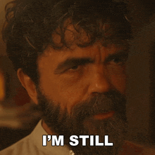 a man with a beard has the words in charge written on his face