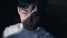 a close up of a young man 's face with blood on his face