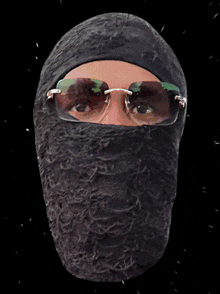 a statue of a person wearing glasses and a black mask