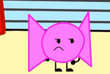 a pink candy with a sad face on it