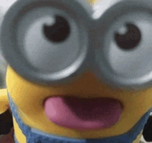 a close up of a toy minion with his tongue out .