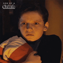 a young boy is holding a blanket in his hands with the words son of a glitch above him