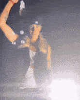 a blurred image of a man wearing a hat with the letter l on it