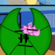 a green cartoon character with a pink flower on its head
