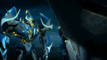 a blue robot with yellow lights on it 's arms
