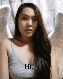 a woman with angel wings says hi on the bottom of her face