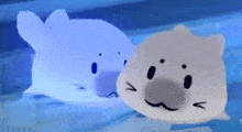 two stuffed animals are sitting next to each other in a pool of water .