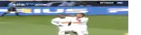 two soccer players are celebrating a goal in front of a sign that says prius on it