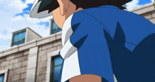 a man in a blue shirt is standing in front of a white building