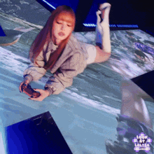 a woman laying on her stomach holding a video game controller with the words look at lalisa on the bottom left