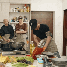 a man wearing a new york yankees hat prepares food