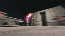 a blurry picture of a person holding a purple light saber